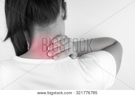 Closeup Woman Suffering From Neck And Shoulder Pain And Injury On Grey Background. Health Care And M