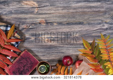 Beautiful Fall Mockup. Dark Old Wooden Background, Bright Colorful Autumn Leaves, Cup Of Hot Tea Wit