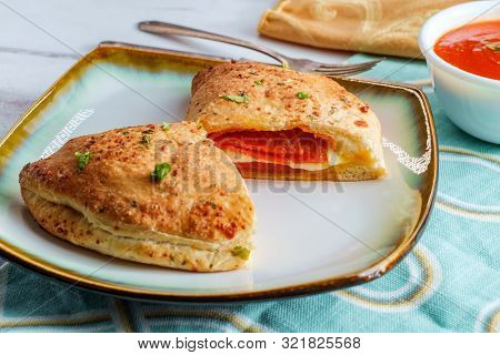 Italian Pastry Pepperoni And Cheese Calzone With Tomato Marinara Dipping Sauce