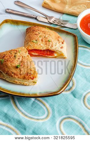 Italian Pastry Pepperoni And Cheese Calzone With Tomato Marinara Dipping Sauce