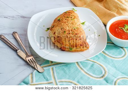 Italian Pastry Pepperoni And Cheese Calzone With Tomato Marinara Dipping Sauce