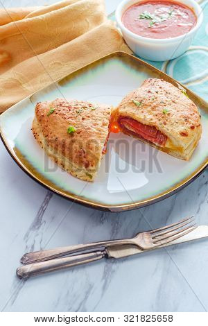 Italian Pastry Pepperoni And Cheese Calzone With Tomato Marinara Dipping Sauce