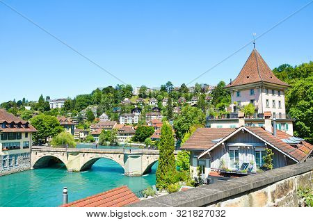 Bridge Over Turquoise Aare River In The Historical Old Town Of The Swiss Capital Bern. Historical Bu