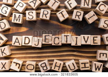 Word Adjective Composed Of Wooden Cubes With Letters, Part Of Speech Concept Scattered Around The Cu