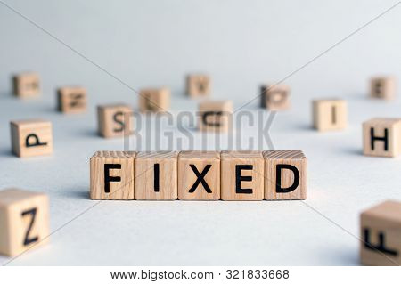 Fixed - Word From Wooden Blocks With Letters, Fixed Interest Rates Or Costs  Concept, Random Letters