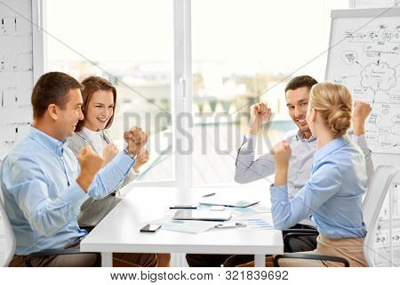business, gesture, people and teamwork concept - happy creative team celebrating seccess at office