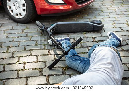 Man After Accident On Electric Scooter Overrun By Car