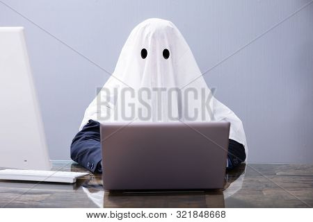 Ghostwriter Writing Article On Laptop In Office