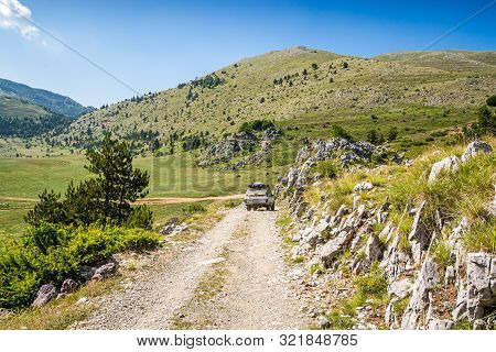 Fushe Lure, Albania - July 25, 2019. Vintage Off Road Car Going On Dirt Road In National Park Lure, 