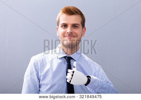 Businessperson With Prosthetic Limb Showing Thumb Up. Artificial Limb