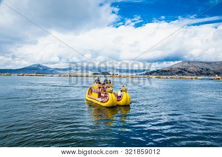 Uros, Peru - Jan 5, 2019. Tourists travel by Traditional Totora boat on Uros floating islands at Titicaca lake i, Puno, Peru, South America.