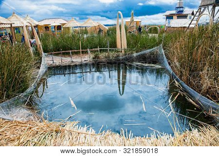 Uros, Peru - Jan 5, 2019. Small pool for fishes at  Uros floating islands on Titicaca lake in Puno, Peru, South America.