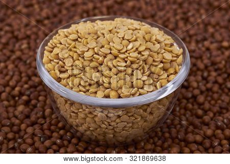 Bowl Containing Split Pigeon Pea (cajanus Cajan) Or Congo Pea Against Whole Pigeon Pea Background