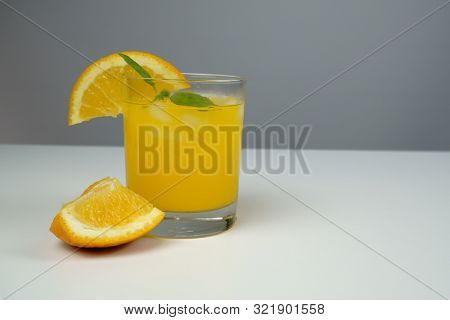 A Glass Of Fresh Orange Juice On White Table