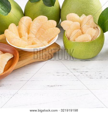 Fresh Peeled Pomelo, Pummelo, Grapefruit, Shaddock On Bright Wooden Table Background. Seasonal Fruit