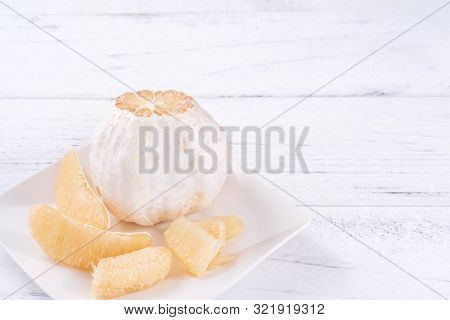 Fresh Peeled Pomelo, Pummelo, Grapefruit, Shaddock On Bright Wooden Table Background. Seasonal Fruit