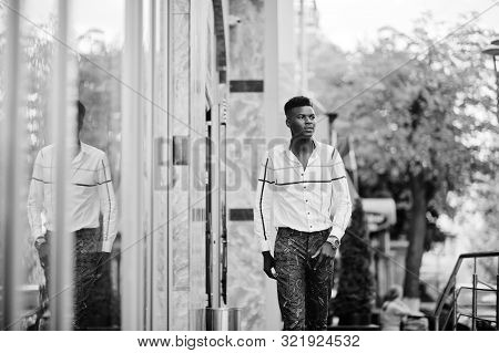 Portrait Of Handsome Stylish African American Model Man In Red Throusers And White Shirt.