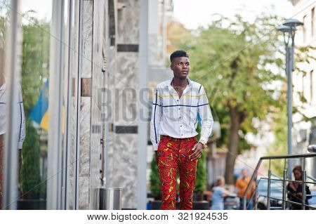Portrait Of Handsome Stylish African American Model Man In Red Throusers And White Shirt.