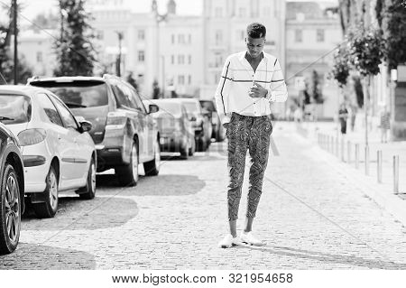 Portrait Of Handsome Stylish African American Model Man In Red Throusers And White Shirt Posed At St