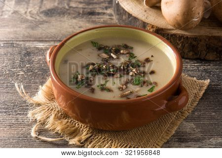 Homemade Mushroom Soup In Bowl On Wooden Table.