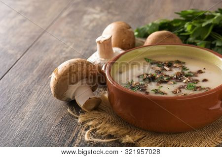 Homemade Mushroom Soup In Bowl On Wooden Table. Copy Space