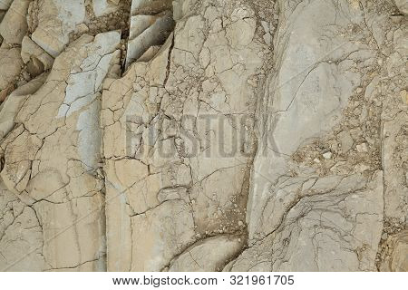 Gray Rough Rough Rock With Large Cracks.