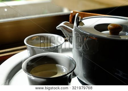 Closeup Chinese Teapot And Two Ceramic Cups, Filled With Hot Tea