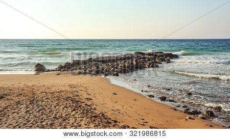 Empty Beach With Footsteps, Some Rocks In Sea, In Evening Few Moments Before Sunset. Lapta, Northern