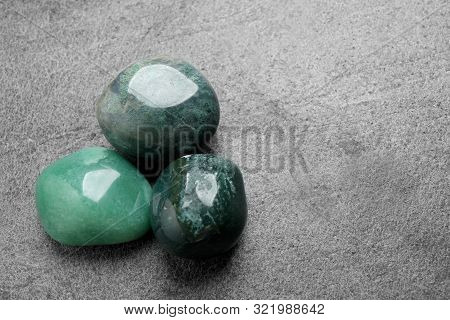 Flat Lay Composition With Green Gemstones On Grey Table, Space For Text