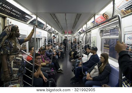 New York, New York/usa - May 17, 2019: People Riding Subway Through Manhattan.
