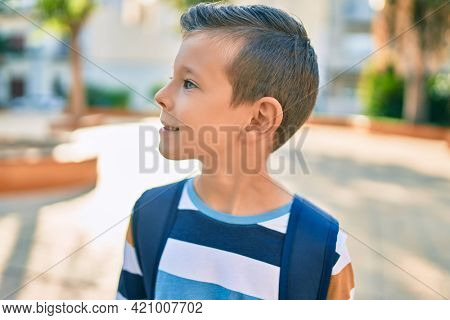 dorable caucasian student boy smiling happy standing at the park.