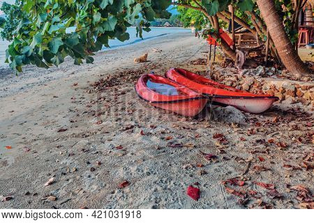  Two  kayask canoes on a tropical beach in evenig time. Thailand