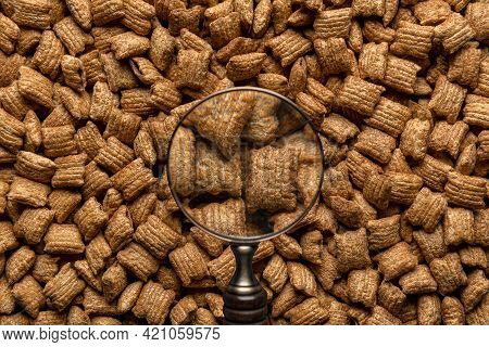 Breakfast Caramel Cereals Square-shaped With Chocolate Filling, View Through A Magnifying Glass. Ful