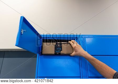 Sabadell, Spain - 30 March 2021 - Young Man's Hand Picking Up A Package From An Amazon Locker In Spa