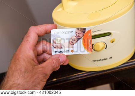 Paris, France - May 7 2021: Pov Male Hand Holding New Medela Made In Switzerland Pumps For Breastfee