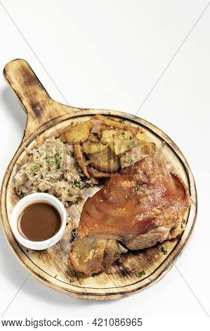Schweinshaxe Traditional German Pork Knuckle With Sauerkraut And Potatoes Meal On White Background