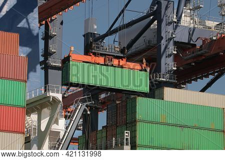 Cargo containers loaded on a huge ship in an intermodal freight terminal