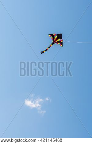Multicoloured One-string Stunt Kite Against Sky. Delta-shape Kite