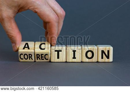 Action Or Correction Symbol. Businessman Turns Wooden Cubes And Changes The Word Correction To Actio
