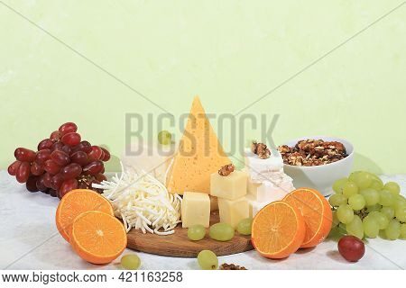 Assortment Of Different Types Of Cheeses, Grapes And Nuts, Healthy And Natural Food Selection, Adver
