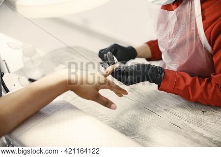 African Girl Doing Manicure In A Beauty Salon