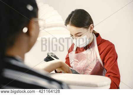African Girl Doing Manicure In A Beauty Salon