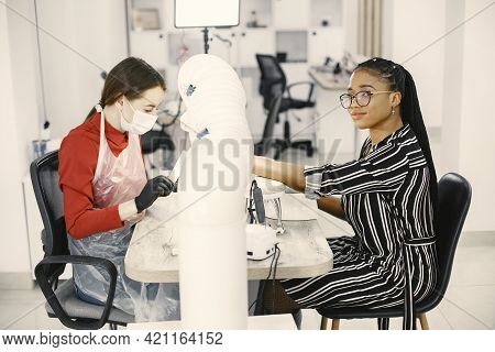 African Girl Doing Manicure In A Beauty Salon
