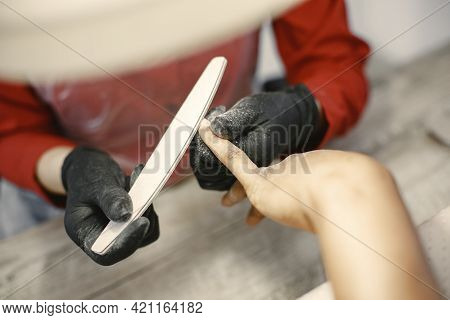 African Girl Doing Manicure In A Beauty Salon