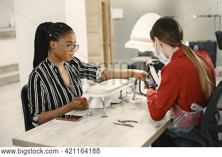 African Girl Doing Manicure In A Beauty Salon