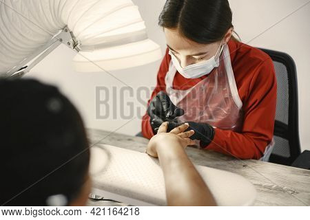 African Girl Doing Manicure In A Beauty Salon