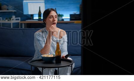 Emotional Young Woman Eating Popcorn While Watching Disgusting Tv Program Movie Alone In Living Room
