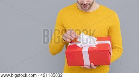 Unshaven Man Cropped View Untie Bow On Present Box Grey Background Copy Space, Gift