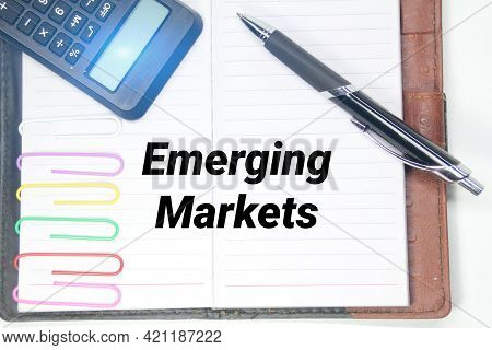 Emerging Market Writing Concepts With Pens, Books And Calculators
