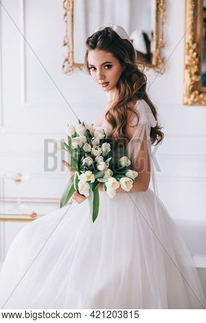 Portrait Of A Beautiful Bride With A Bouquet In Studio